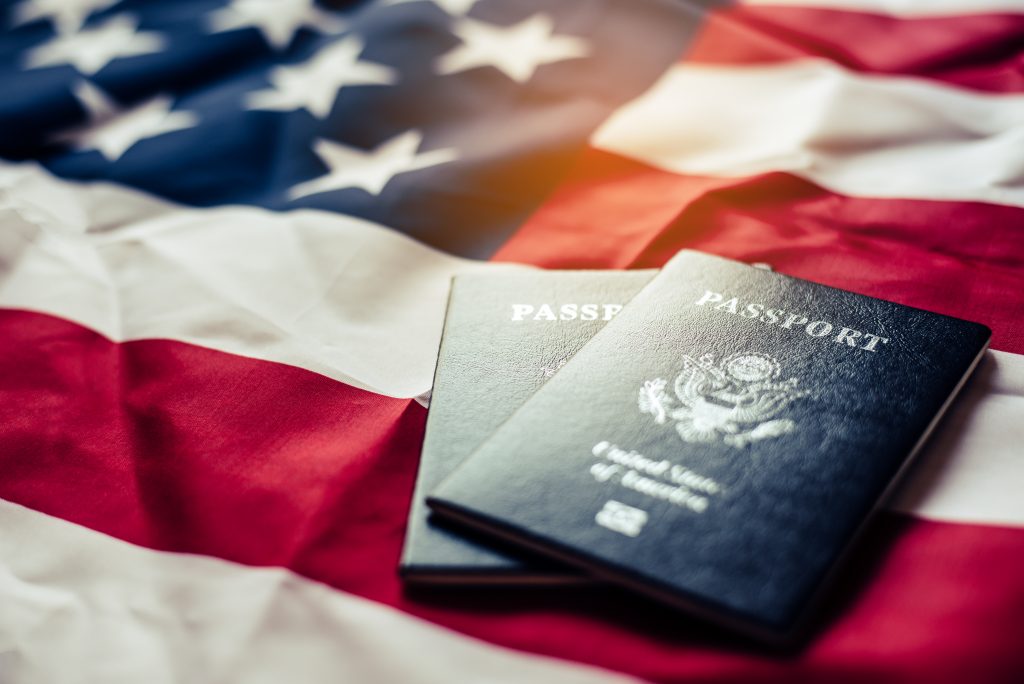 Passport is placed on the US flag. Preparing for a legitimate jo
