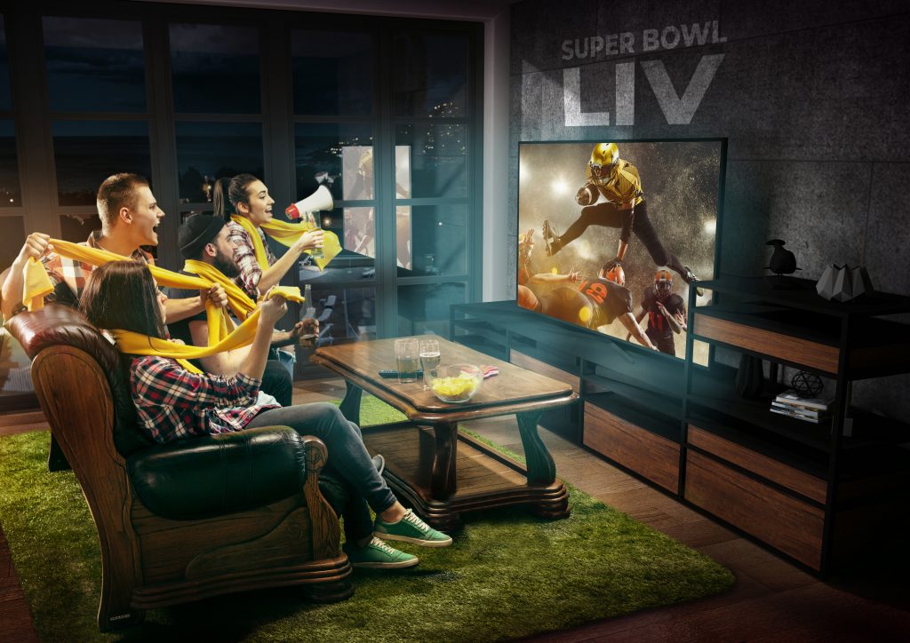 Group of friends watching TV, american football championship