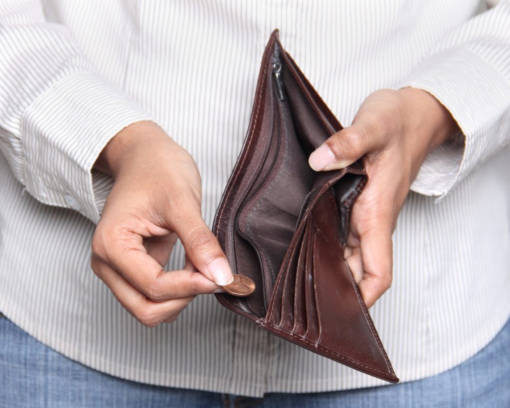 Person taking a penny from wallet - Bankruptcy