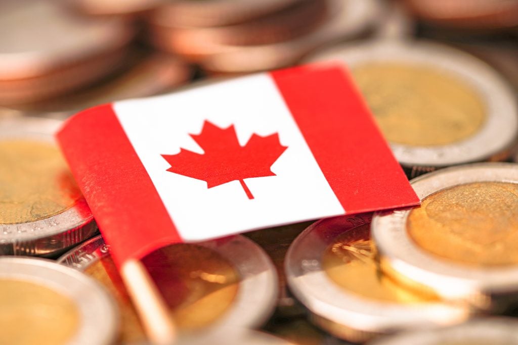 Canada Flag on coins background : Business and finance concept richest 