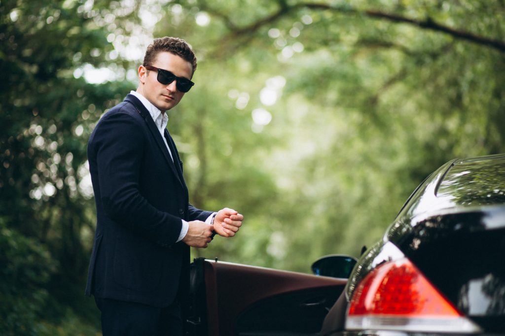 handsome man by luxury car