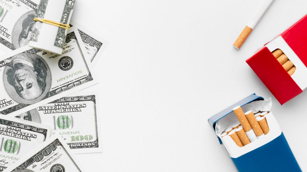 dollar bills and tobacco cigarettes impact finances