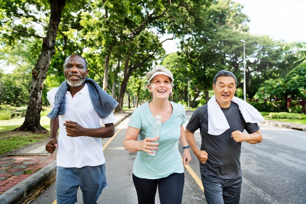 group of senior friends jogging together activities exercise park daily exercise