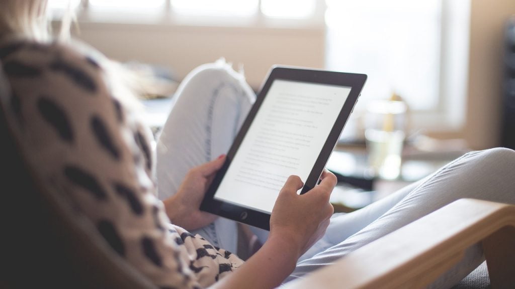 person reading ebook on tablet ebook reader