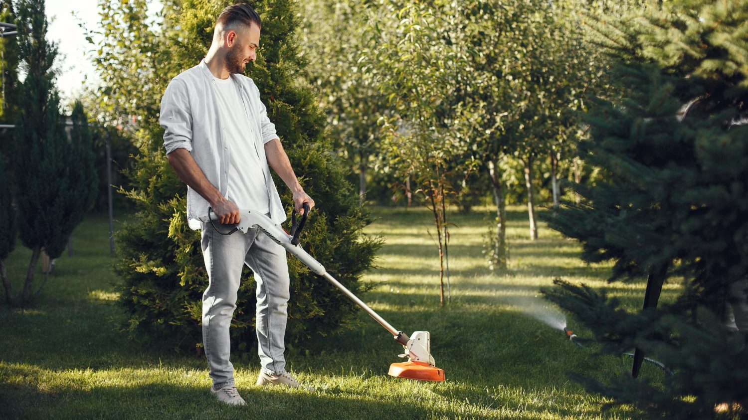 man cutting grass with law mover back yard exercise activity