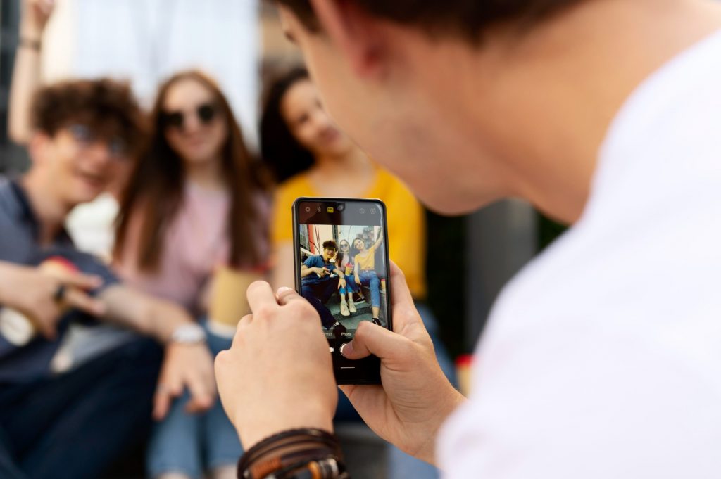 man taking photo of his friends with photo editing apps