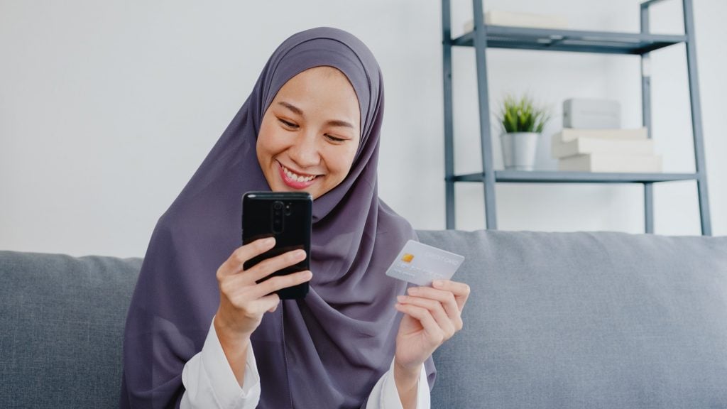 muslim lady using credit card and online banking