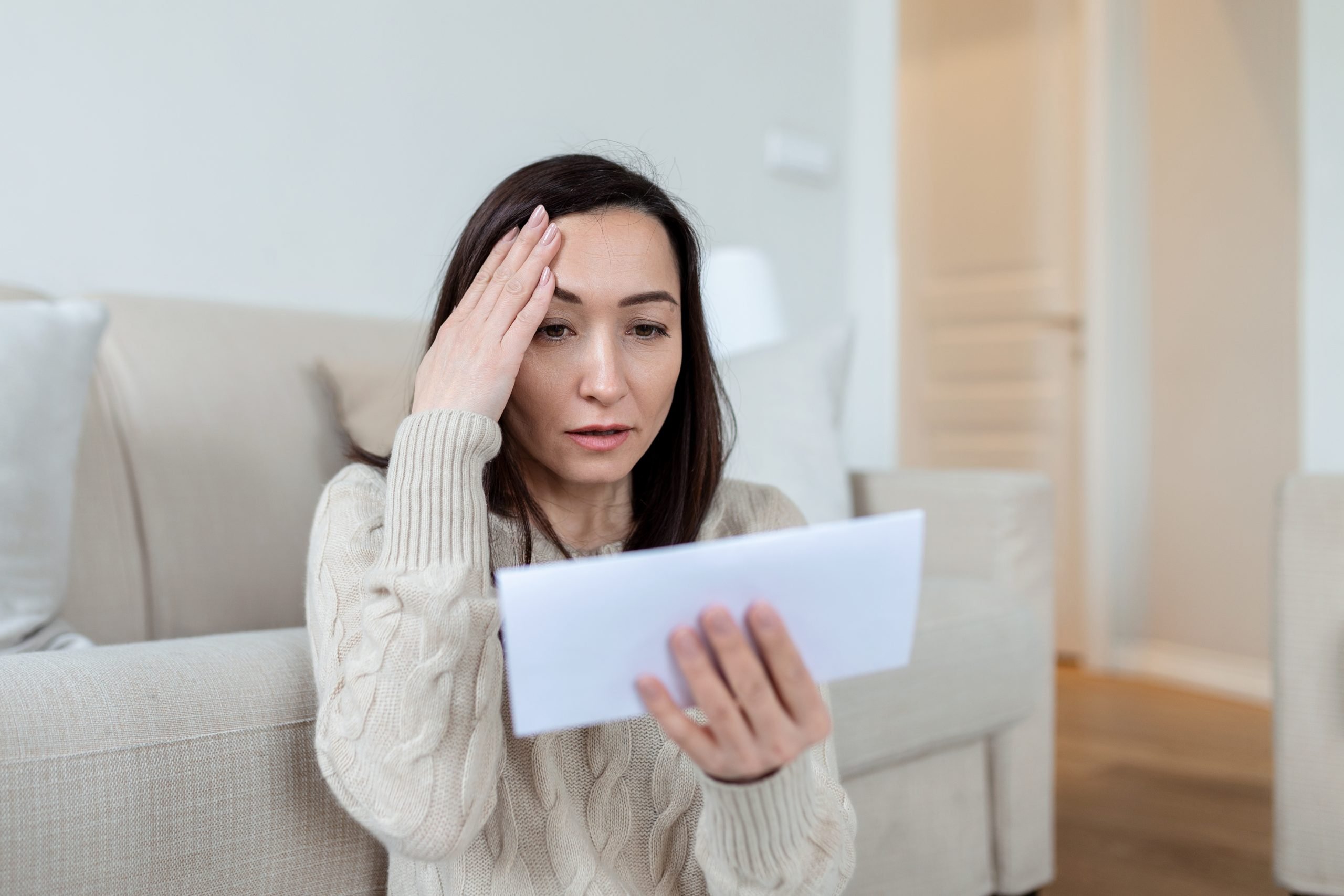 worried woman looking at high bills bankrupt