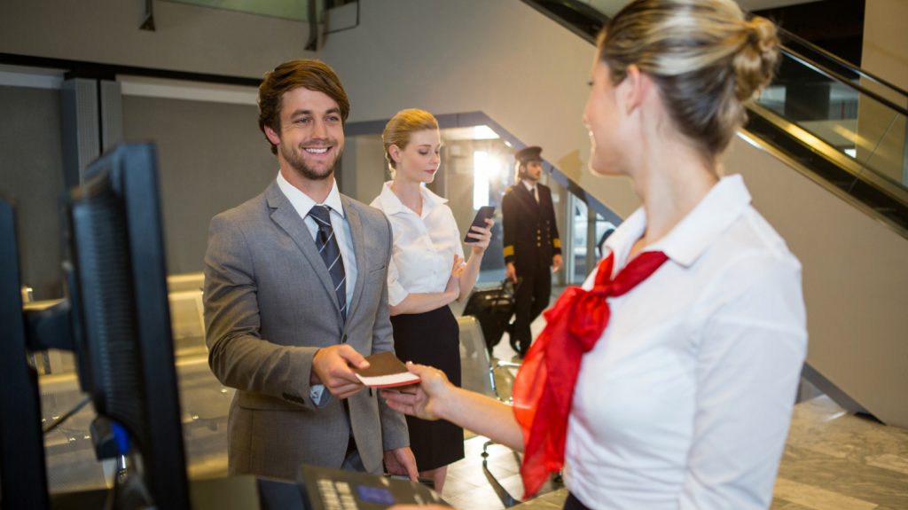 business man giving boarding pass female staff