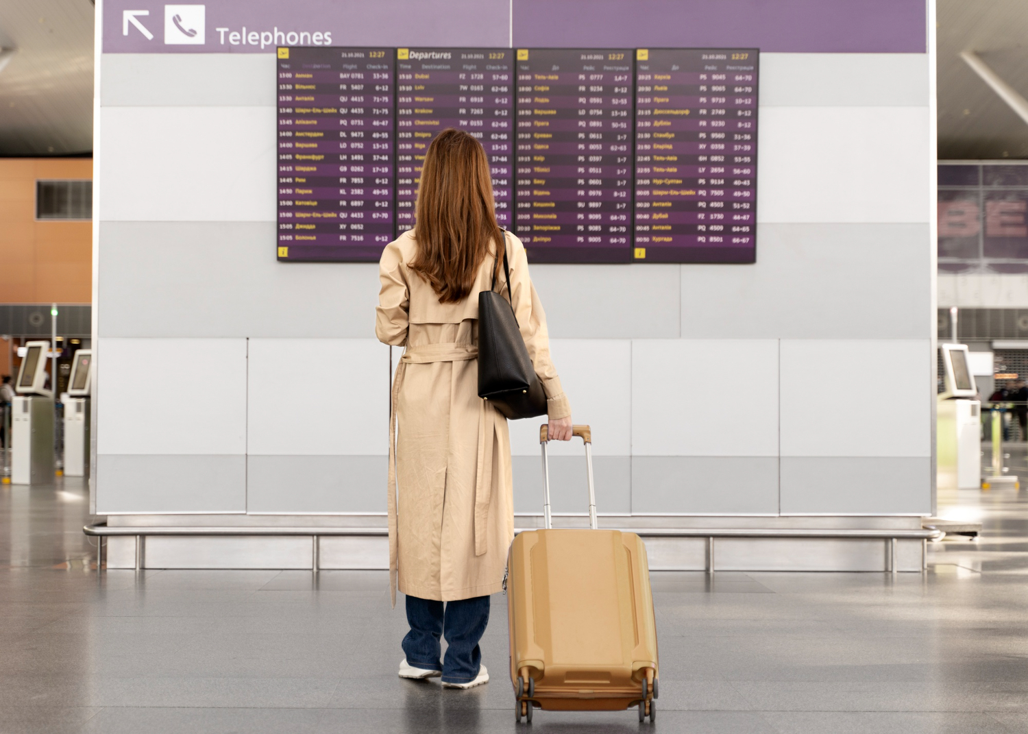 woman standing in front of airport travel best places