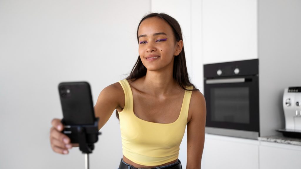 smiley young woman recording video for tiktok instagram