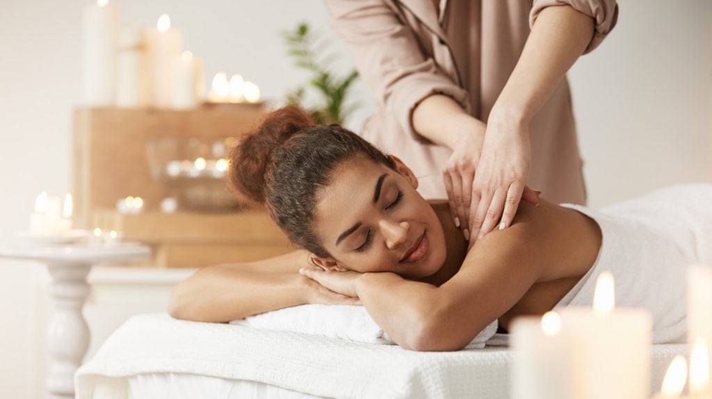 woman smilling enjoying massage spa resort travel perks