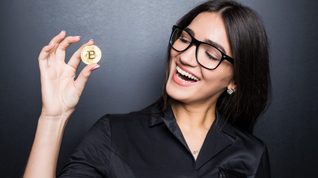 woman holding bitcoin cryptocurrency