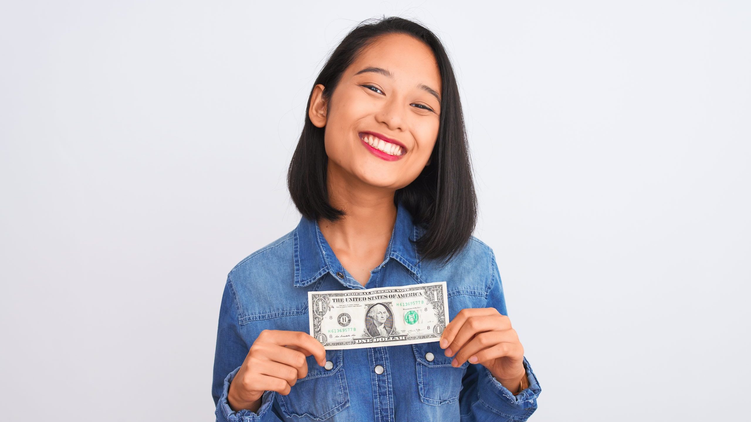 young woman smiles buying cheap stuff online with one dollar