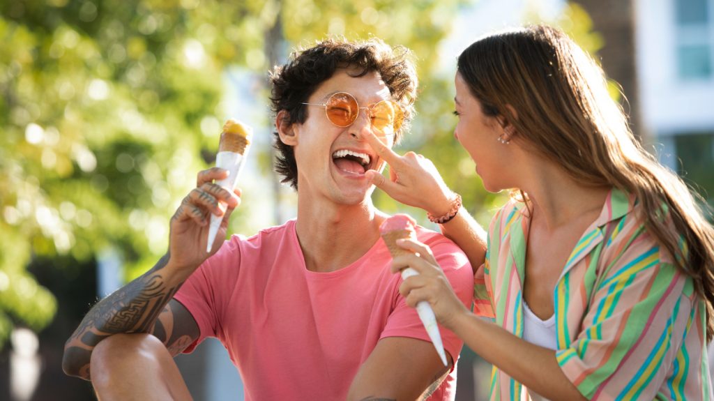 happy couple smilling eating ice cream togehter