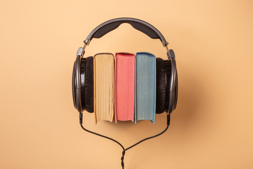 headphones on books, audiobooks concept